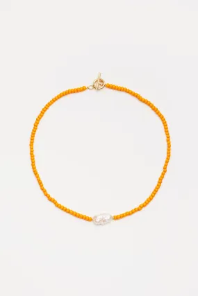 Beaded orange necklace with pearl pendant