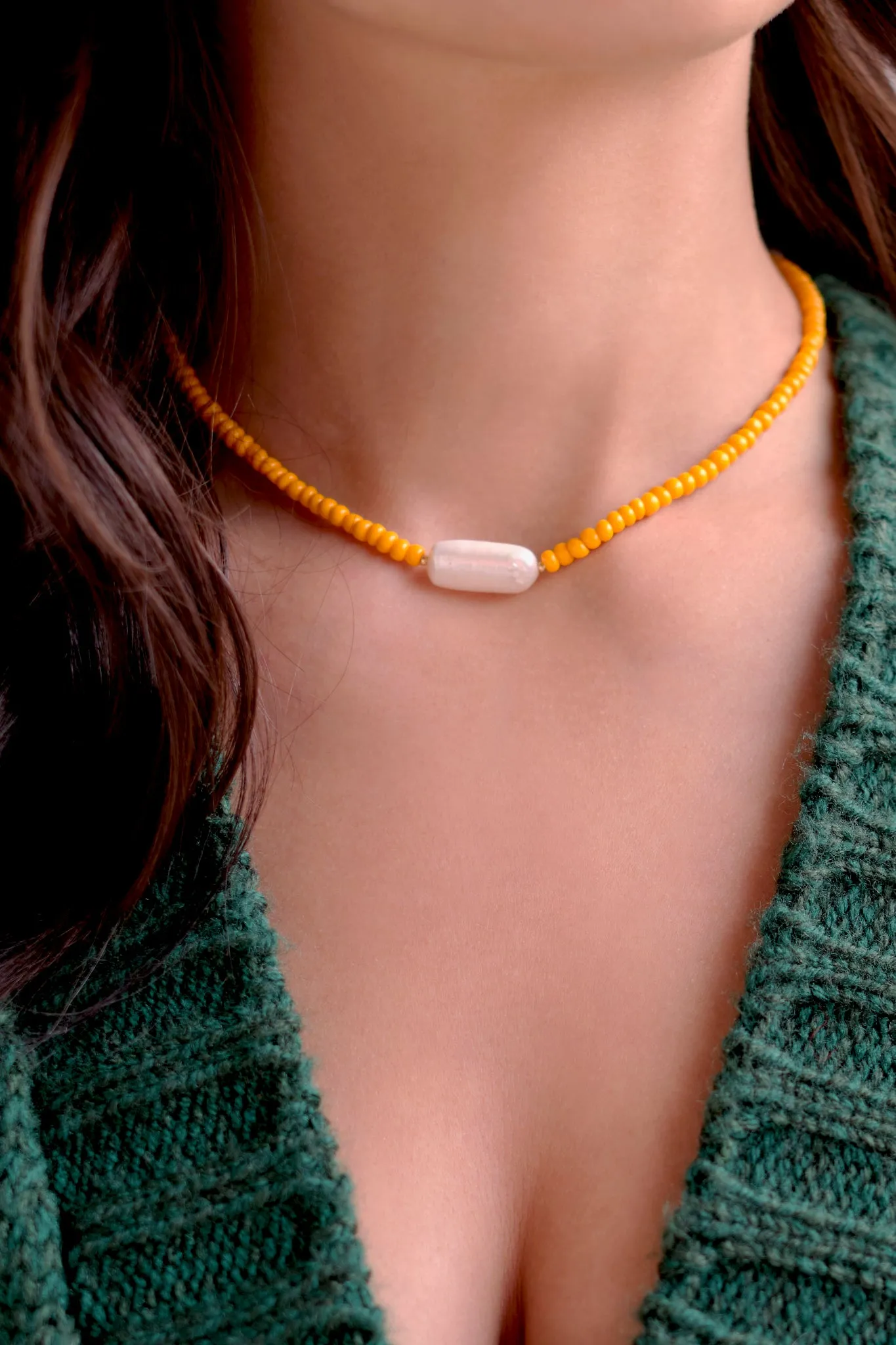 Beaded orange necklace with pearl pendant